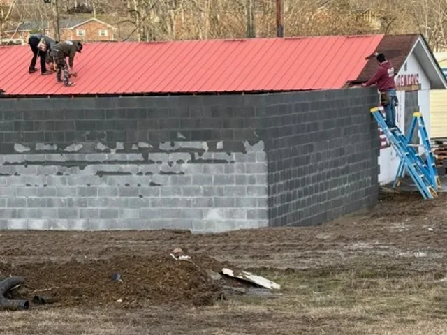 The store being expanded, with new walls and a new roof going up.